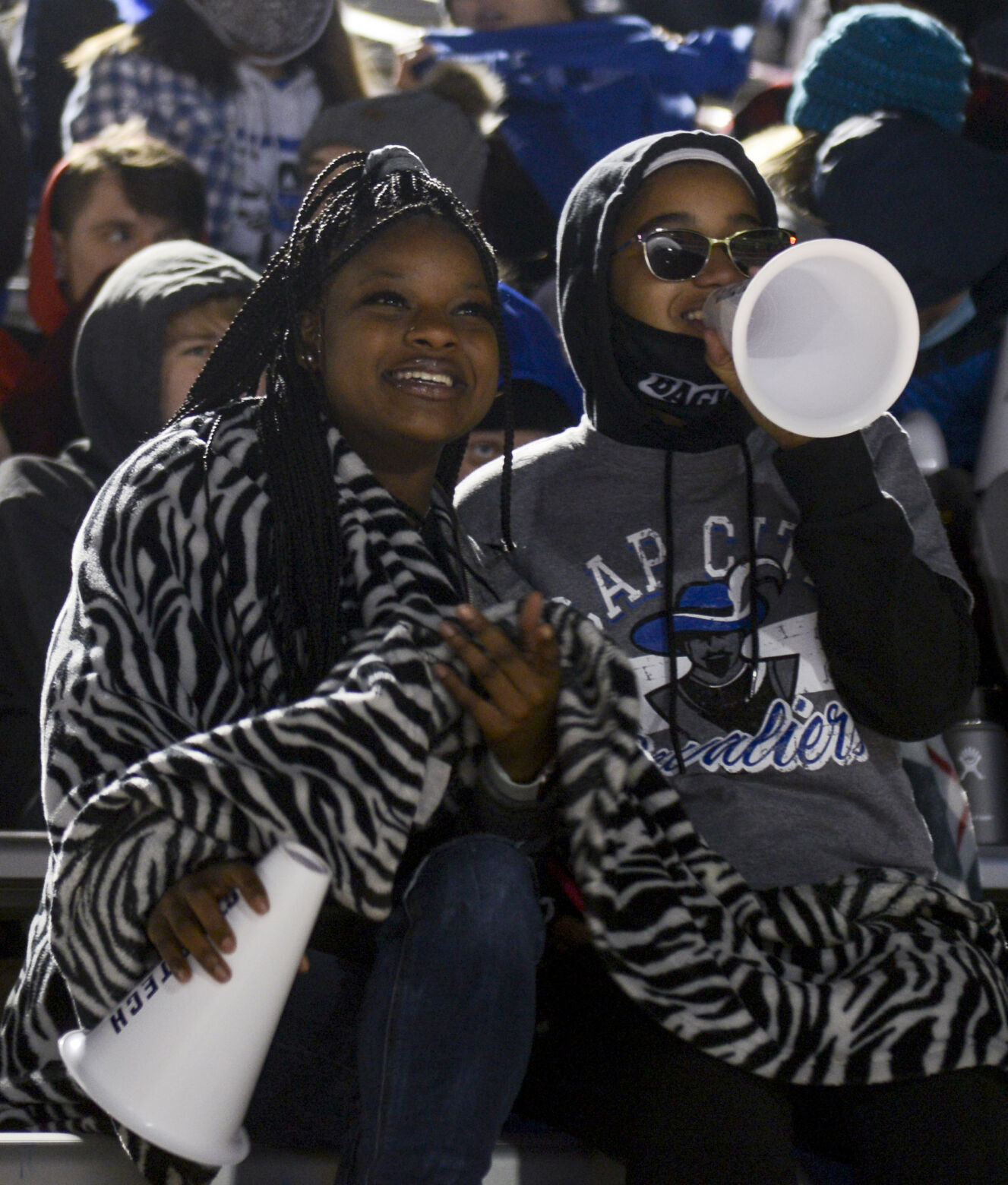 From left, Capital City High School recent graduate Kaylee Ware and sophomore Serenity Moore watch the Capital City Cavaliers face the Kirksville Tigers